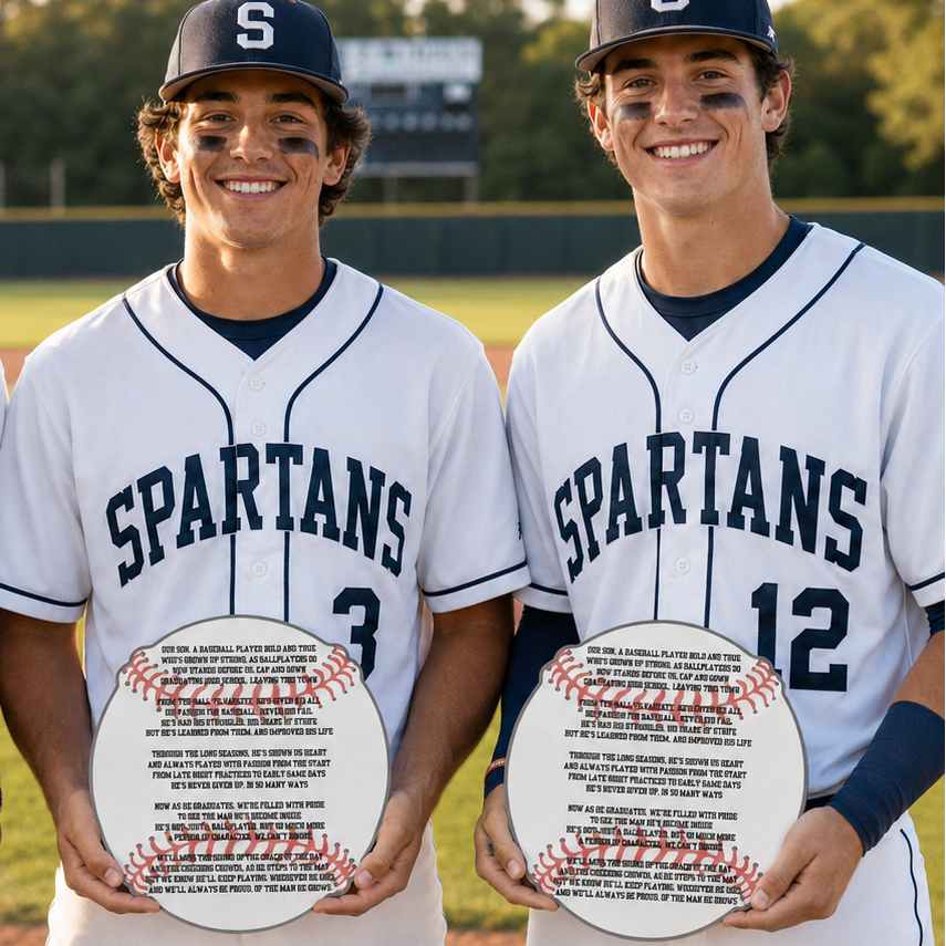 Two baseball players in Spartans uniforms holding commemorative plates on a baseball field.