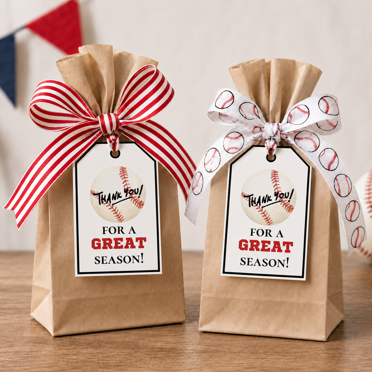 Two brown paper bags with baseball-themed ribbons and tags on a wooden surface.